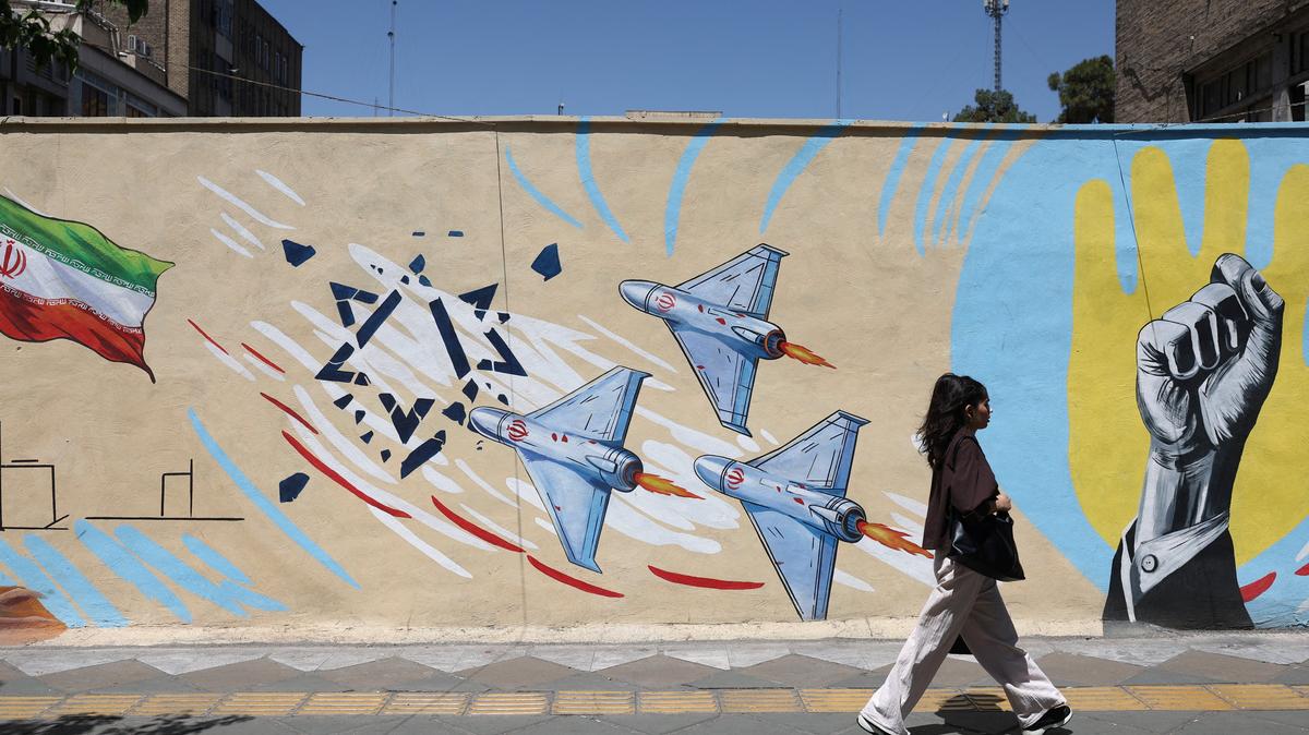 An Iranian woman walks next to an anti-Israeli mural on a street in Tehran, Iran, May 30, 2026. Majid Asgaripour/WANA (West Asia News Agency) via REUTERS