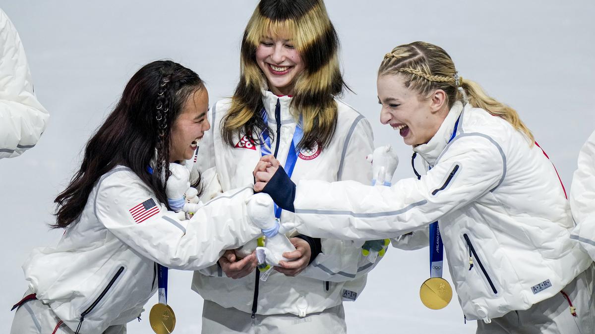 From left: Ellie Kam, Alysa Liu and Amber Glenn of the United States celebrate after their team won gold in the figure skating team event at the 2026 Milan Cortina Winter Olympics in Milan, Italy, on Sunday, Feb. 8, 2026. (Vincent Alban/The New York Times)