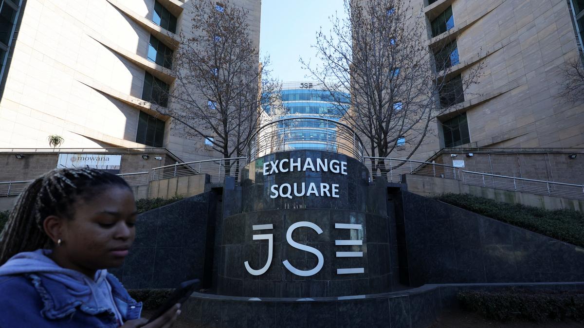 FILE PHOTO: A woman walks at the Johannesburg Stock Exchange (JSE), in Sandton, South Africa, August 1, 2025. REUTERS/Siphiwe Sibeko/File Photo