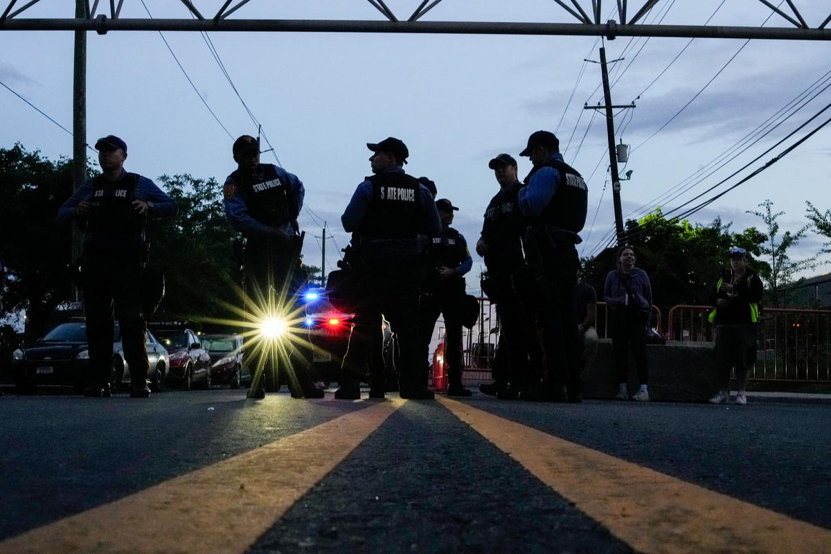 New Jersey State Policemen stand guard as they set up a protest zone outside the Delaney Hall detention center, while demonstrators remain gathered outside, in Newark, New Jersey, U.S., May 29, 2026. REUTERS/Eduardo Munoz