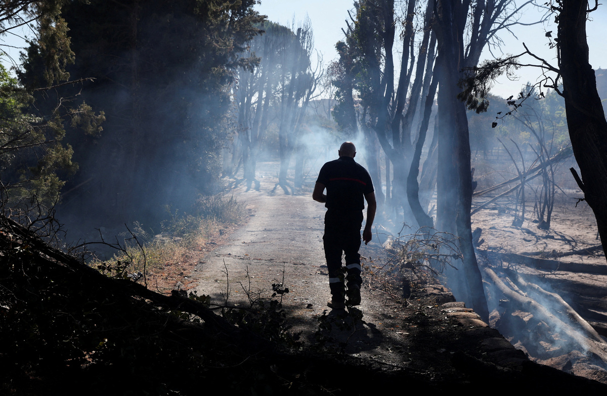 A firefighter walks, following a wildfire in Ille-sur-Tet near Perpignan, France July 6, 2026. REUTERS/Bruna Casas