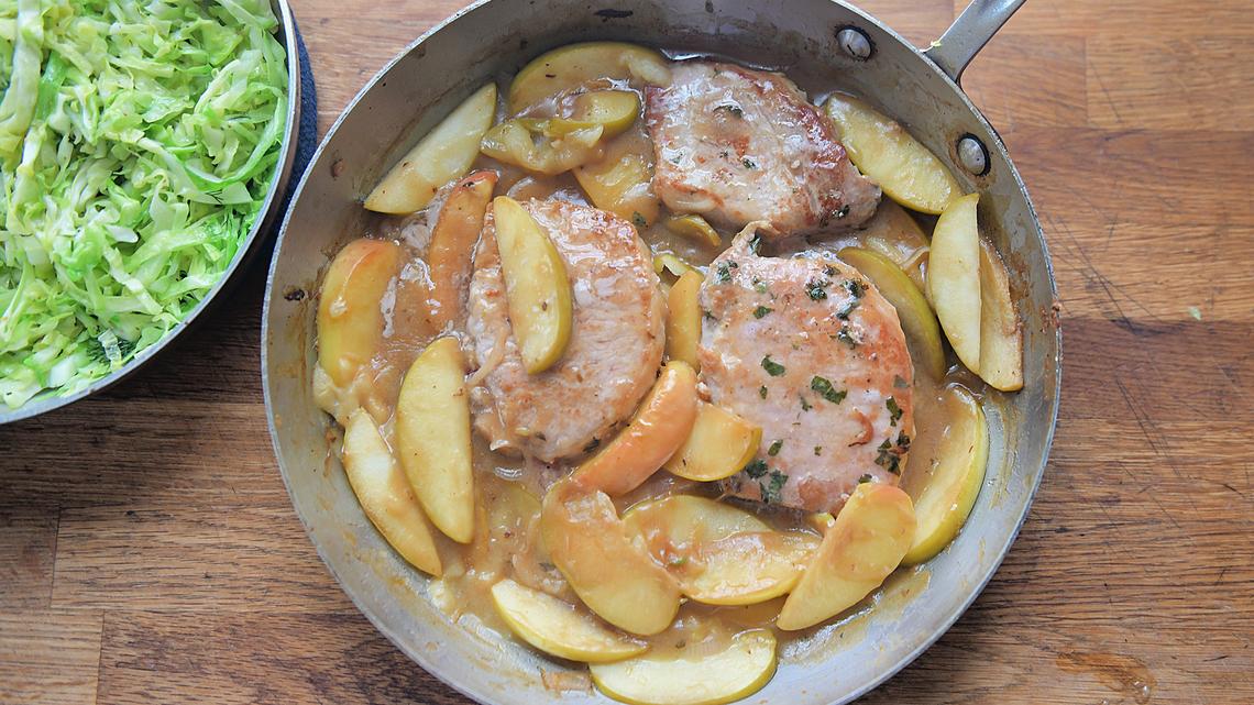One-pot recipe brings together pork chops, apples and warm cabbage slaw