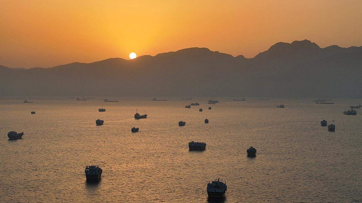 A drone view shows vessels anchored at the Strait of Hormuz, as seen from Musandam, Oman, on Saturday. U.S. Central Command has guided about 70 commercial ships through the strait, traveling into and out of the Persian Gulf, in the past three weeks, a U.S. official said.