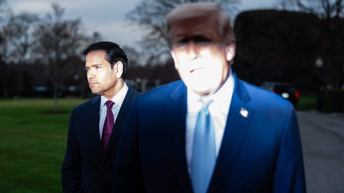 Secretary of State Marco Rubio listens as President Donald Trump speaks to reporters before boarding Marine One outside of the White House in Washington on March 20. As President Trump prepares to send a delegation to the latest round of U.S.-Iran talks in Pakistan, his secretary of state will remain where he often does: at home.