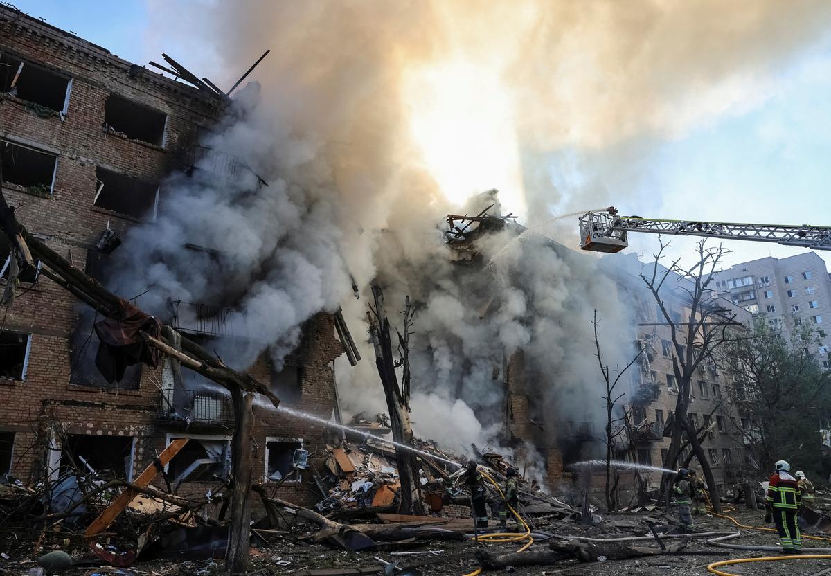 Firefighters work at the site of an apartment building destroyed by a Russian missile and drone strike, amid Russia's attack on Ukraine, in Kyiv, Ukraine, May 24, 2026. REUTERS/Stringer