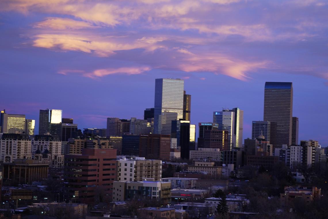  Clouds turn pink over the skyline as the sun rises on November 18, 2020, in Denver. 