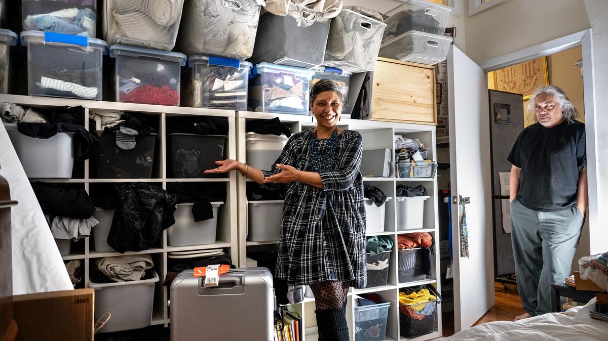 Duwenavue Santé Johnson shows the half of her closet where husband Joseph Carrillo keeps things at her Old City apartment. (Tom Gralish/The Philadelphia Inquirer/TNS)