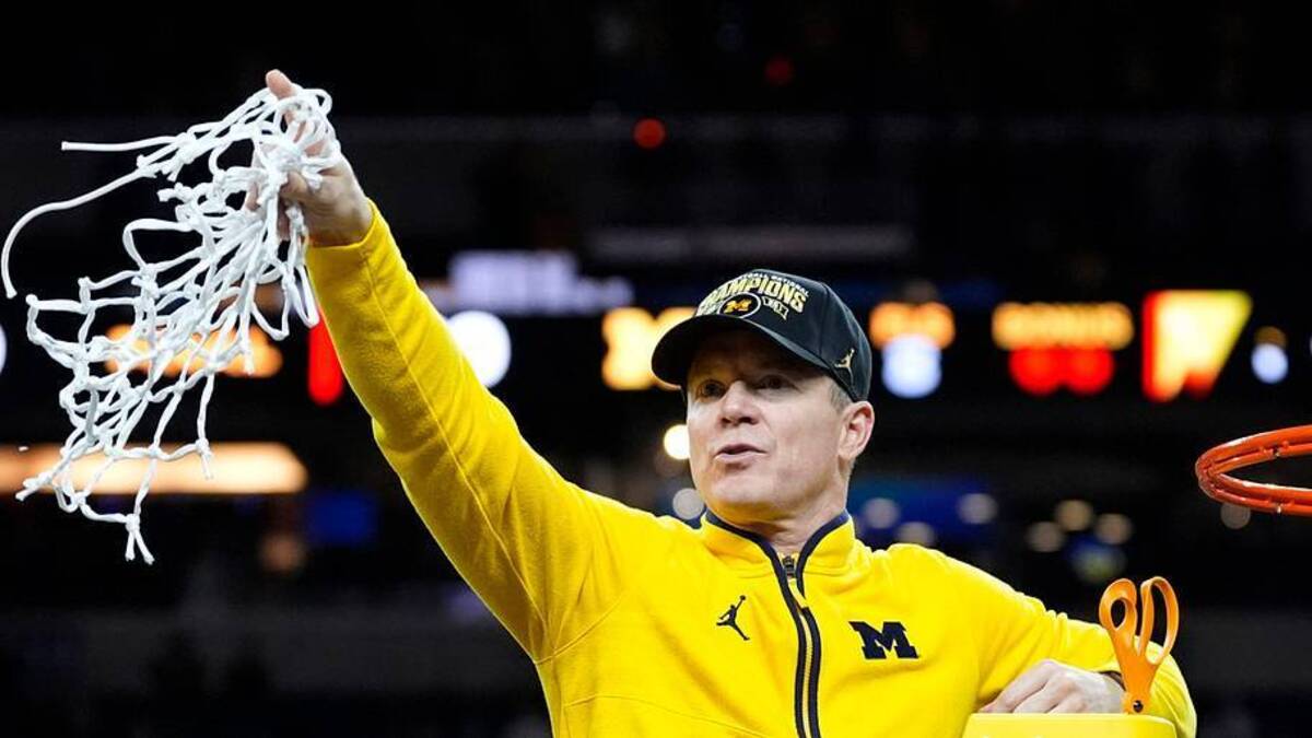  Michigan head coach Dusty May swings the net after winning the NCAA national championship against Connecticut at Lucas Oil Stadium in Indianapolis on Monday, April 6, 2026. | Junfu Han / USA TODAY NETWORK via Imagn Images 