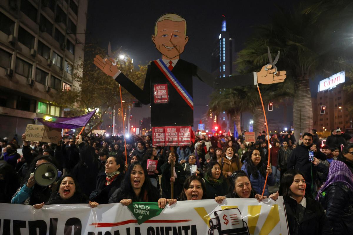 Demonstrators hold a cut out of Chile's President Jose Antonio Kast as they gather to protest against his policies, in Santiago, Chile, June 1, 2026. REUTERS/Pablo Sanhueza