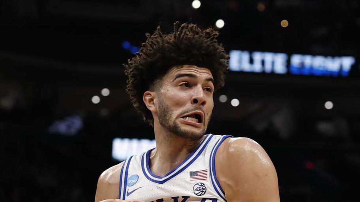 Mar 29, 2026; Washington, DC, USA; Duke Blue Devils forward Cameron Boozer (12) rebounds against the UConn Huskies during an Elite Eight game of the East Regional of the men's 2026 NCAA Tournament at Capital One Arena. Mandatory Credit: Geoff Burke-Imagn Images | Geoff Burke-Imagn Images 