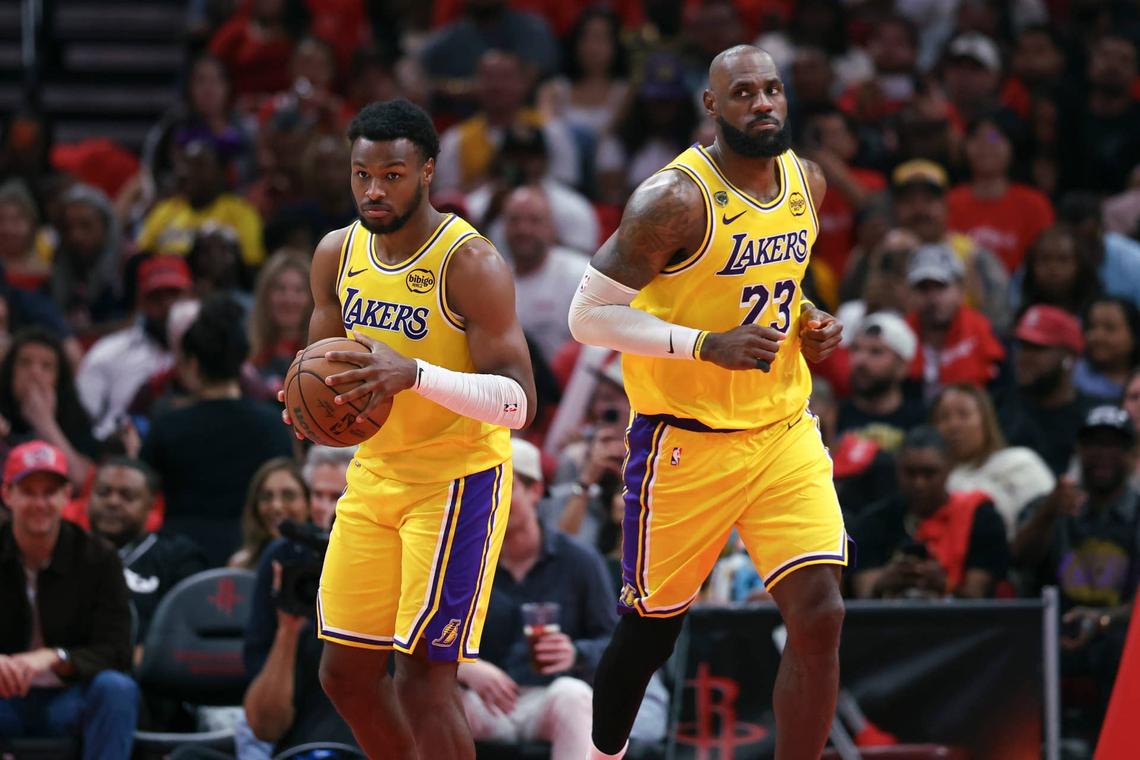  Apr 24, 2026; Houston, Texas, USA; Los Angeles Lakers forward LeBron James (23) gives the ball to guard Bronny James (9) during the fourth quarter against the Houston Rockets during game three of the first round of the 2026 NBA Playoffs at Toyota Center. Mandatory Credit: Troy Taormina-Imagn Images 