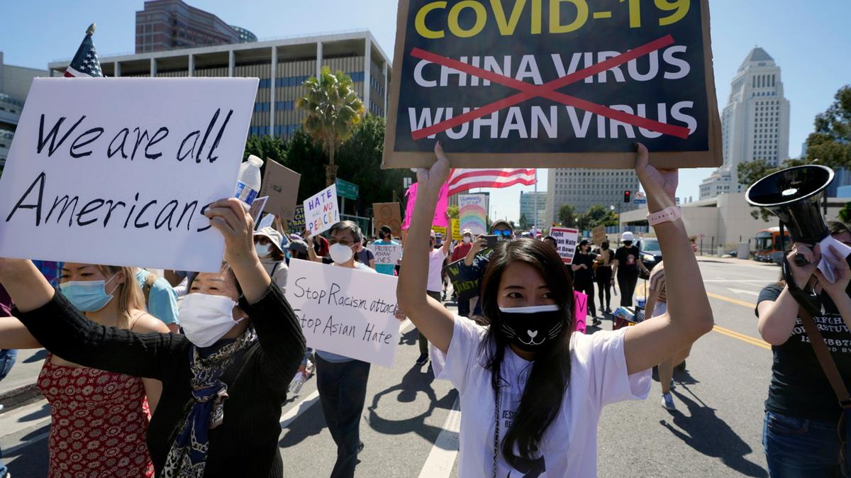 Protestors march at a rally against Asian hate crimes past the Los Angeles Federal Building in downtown Los Angeles , Saturday, March 27, 2021. The gathered crowd demanded justice for the victims of the Atlanta spa shooting and for an end to racism, xenophobia and misogyny. The “LA vs. Hate” initiative encourages people to call 211 if they are victims or witness an incident of hate. (AP Photo/Damian Dovarganes)