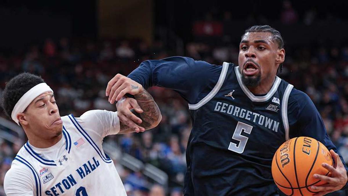  Feb 21, 2026; Newark, New Jersey, USA; Georgetown Hoyas guard KJ Lewis (5) drives to the basket against Seton Hall Pirates guard Adam Clark (0) during the first half at Prudential Center. Mandatory Credit: Vincent Carchietta-Imagn Images | Vincent Carchietta-Imagn Images 