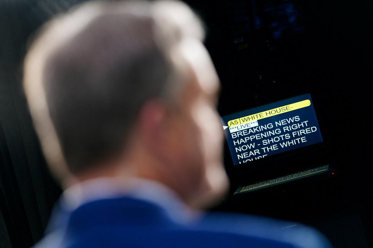 A reporter stands in front of a teleprompter in the press area on the North Lawn of the White House after alleged gunshots were heard nearby, in Washington, D.C., U.S., May 23, 2026. REUTERS/Nathan Howard