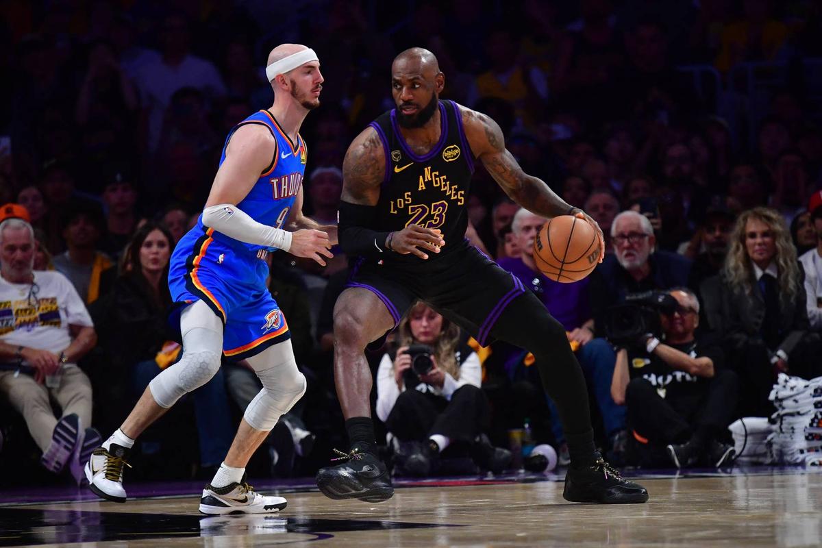  Los Angeles Lakers forward LeBron James operates with the ball as Oklahoma City Thunder guard Alex Caruso defends during their playoff game at Crypto.com Arena on May 11, 2026. Gary A. Vasquez-Imagn Images