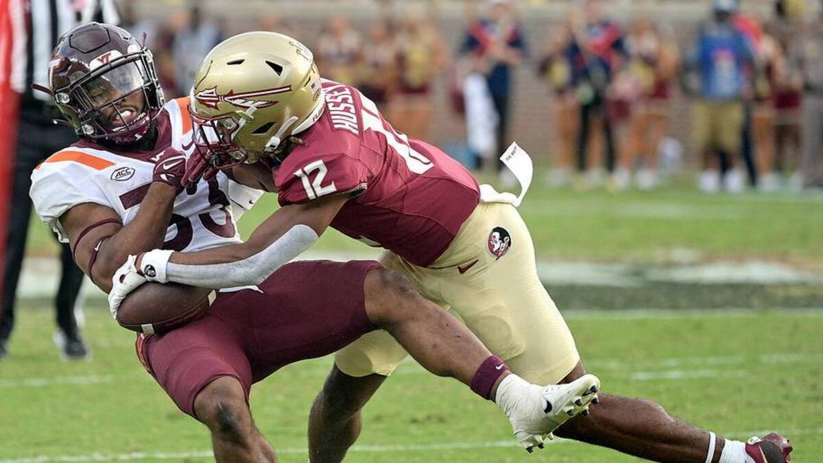  Oct 7, 2023; Tallahassee, Florida, USA; Florida State Seminoles defensive back Conrad Hussey (12) tackles Virginia Tech Hokies running back Bhayshul Tuten (33) during the second half against the at Doak S. Campbell Stadium. Mandatory Credit: Melina Myers-Imagn Images | Melina Myers-Imagn Images 