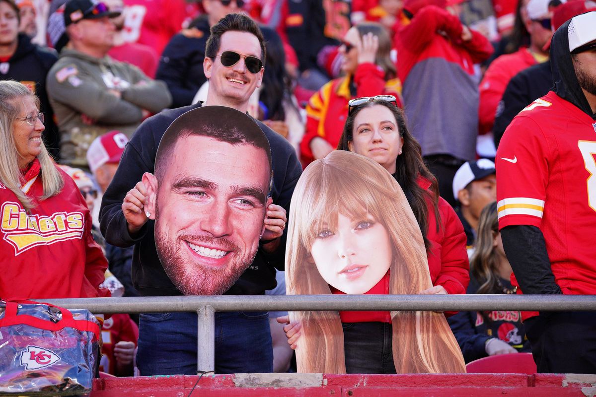 FILE PHOTO: Nov 10, 2024; Kansas City, Missouri, USA; Kansas City Chiefs fans hold fathead signs of Travis Kelce (not pictured) and Taylor Swift during the second half of the game against the Denver Broncos at GEHA Field at Arrowhead Stadium. Denny Medley-Imagn Images/ File Photo