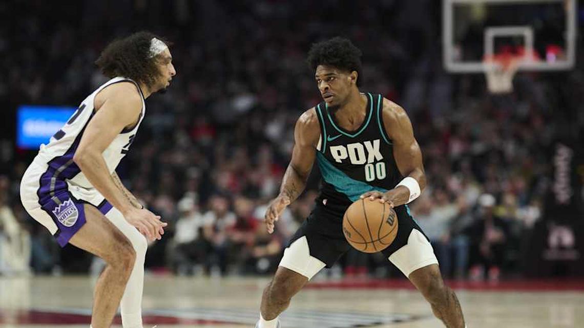  Apr 12, 2026; Portland, Oregon, USA; Portland Trail Blazers guard Scoot Henderson (00) dribbles the ball during the first half against Sacramento Kings guard Devin Carter (22) at Moda Center. | Troy Wayrynen-Imagn Images 