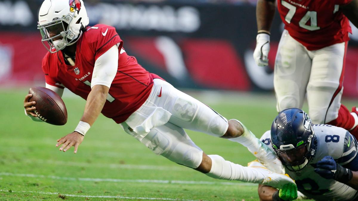Arizona Cardinals quarterback Kyler Murray (1) is sacked by Seattle Seahawks defensive end Carlos Dunlap (8) during the first half of an NFL football game Sunday, Jan. 9, 2022, in Glendale, Ariz. (AP Photo/Ralph Freso)