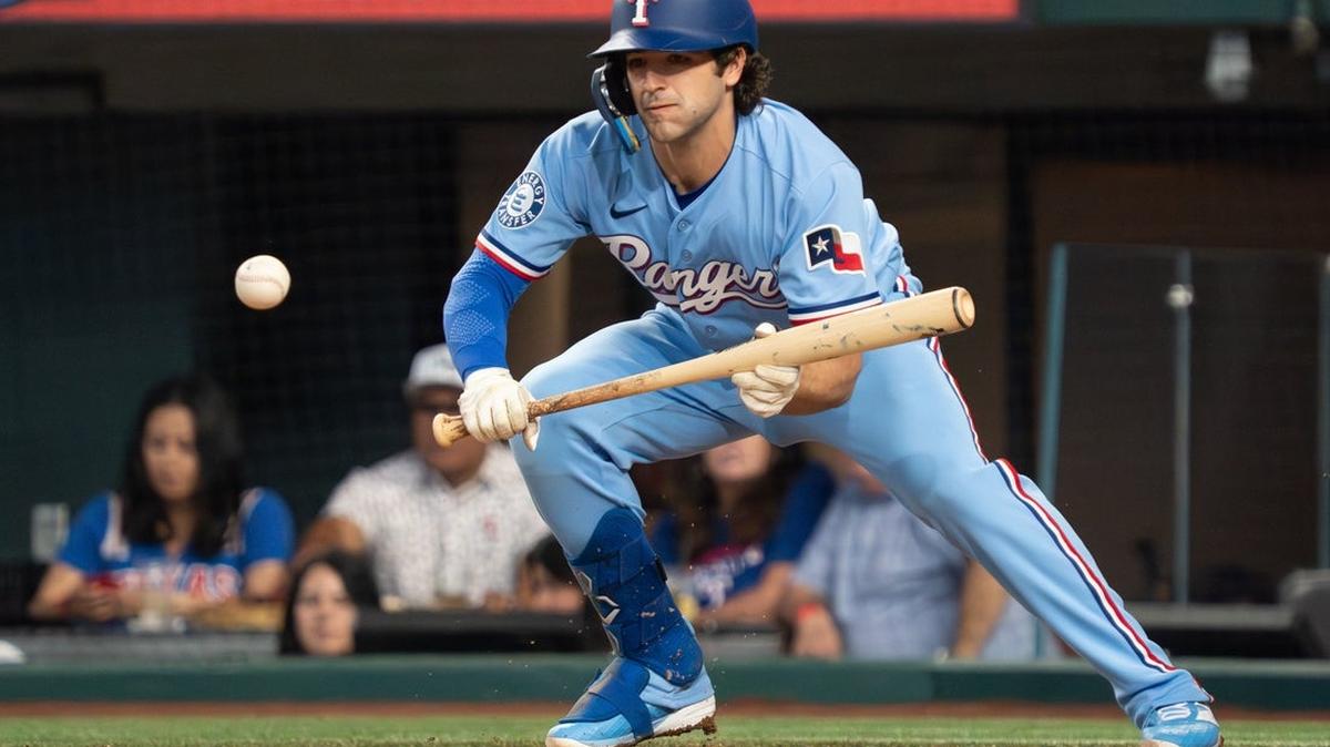 
                 Apr 26, 2026; Arlington, Texas, USA;  Texas Rangers shortstop Josh Smith (8) lays down a bunt single during the sixth inning against the Athletics at Globe Life Field. Mandatory Credit: Raymond Carlin III-Imagn Images 
              