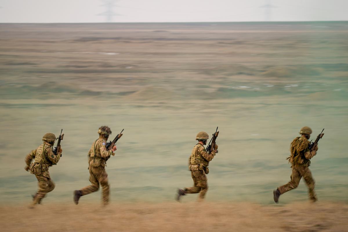  Servicemen run during the Steadfast Dart 2025 exercise, involving some 10,000 troops in three different countries from nine nations, representing the largest NATO operation planned last year, at a training range in Smardan, eastern Romania, Wednesday, February 19, 2025. (AP Photo) 
