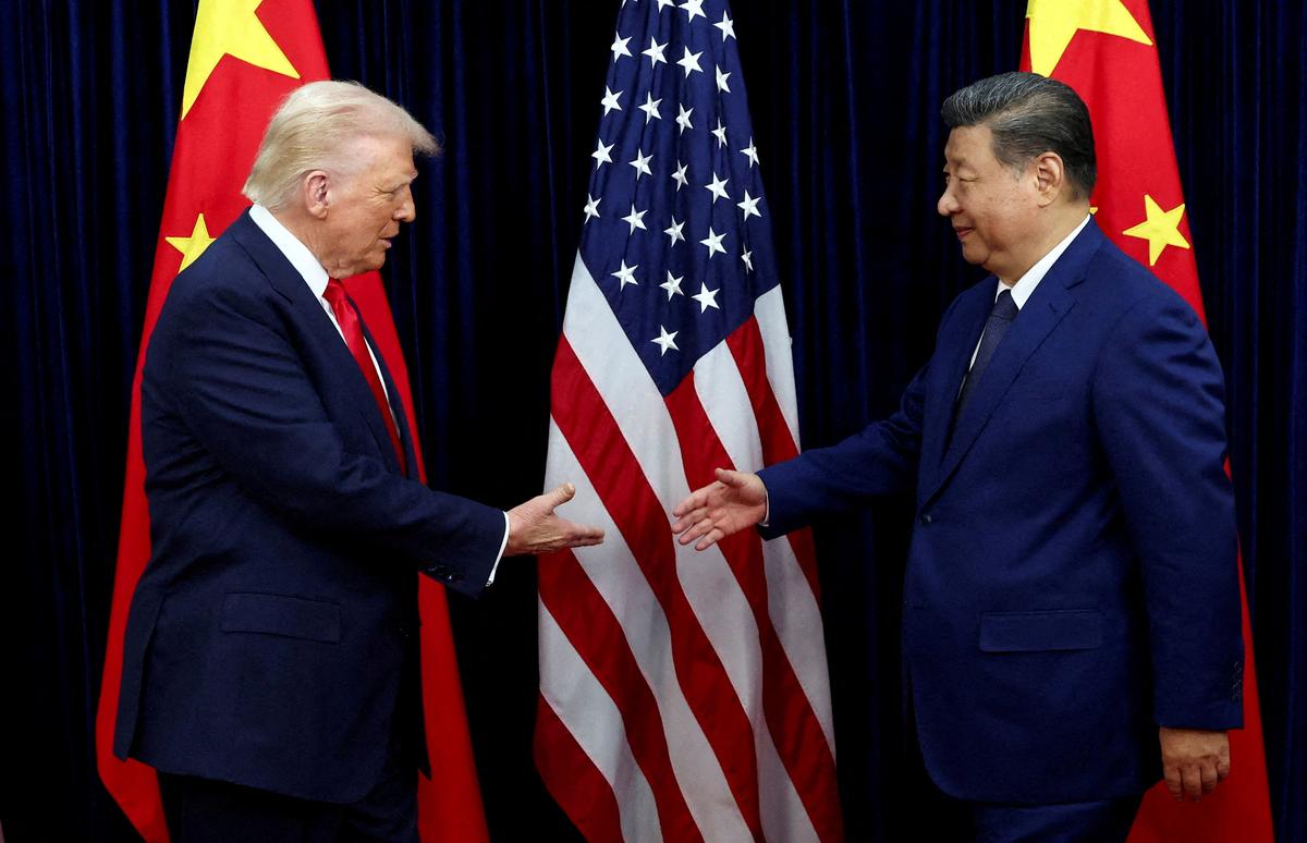 FILE PHOTO: FILE PHOTO: U.S. President Donald Trump shakes hands with Chinese President Xi Jinping as they hold a bilateral meeting at Gimhae International Airport, on the sidelines of the Asia-Pacific Economic Cooperation (APEC) summit, in Busan, South Korea, October 30, 2025. REUTERS/Evelyn Hockstein/File Photo/File Photo