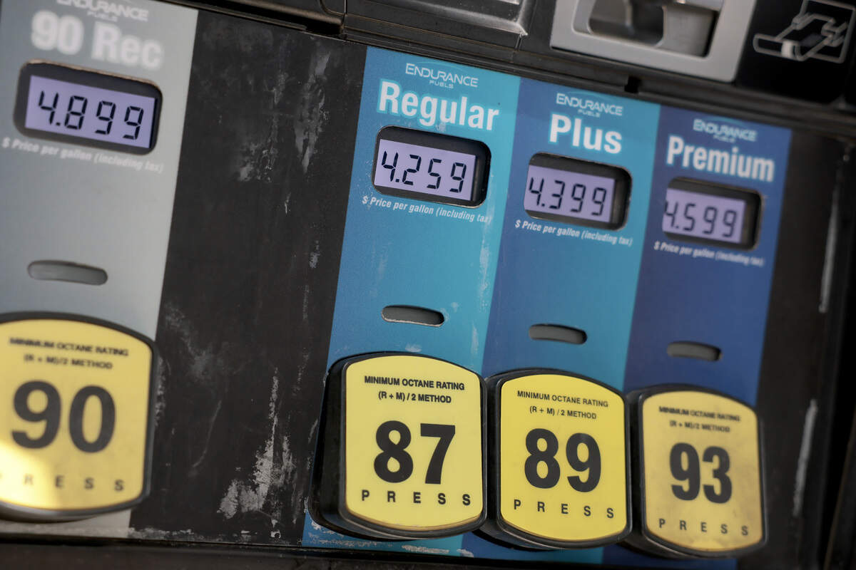 A fuel pump displays prices at a gas station.