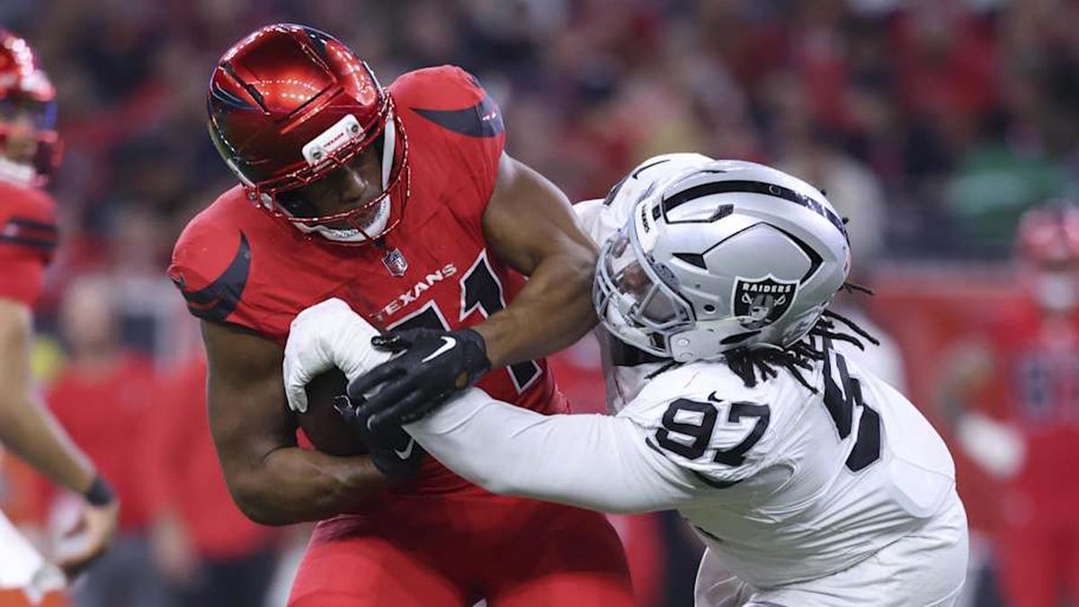  Dec 21, 2025; Houston, Texas, USA; Houston Texans running back Nick Chubb (21) runs with the ball as Las Vegas Raiders defensive tackle Tonka Hemingway (97) makes a tackle during the fourth quarter at NRG Stadium. Mandatory Credit: Troy Taormina-Imagn Images | Troy Taormina-Imagn Images 