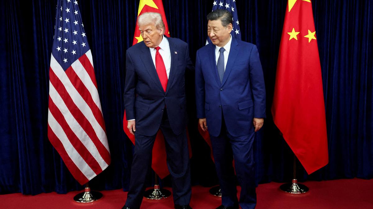 FILE PHOTO: U.S. President Donald Trump and Chinese President Xi Jinping walk, as they hold a bilateral meeting at Gimhae International Airport on the sidelines of the Asia-Pacific Economic Cooperation (APEC) summit in Busan, South Korea, on October 30, 2025. REUTERS/Evelyn Hockstein/File Photo