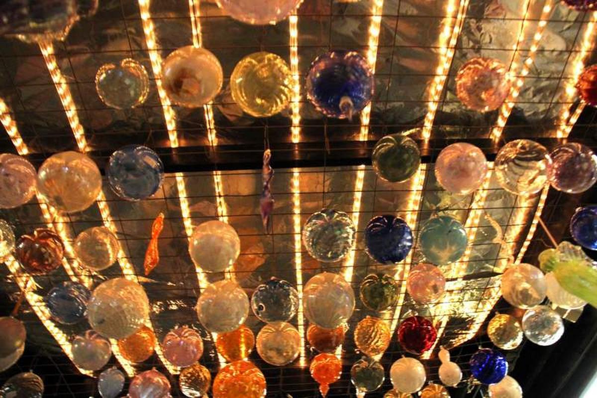  The ceiling of the Crystal Forge glass studio is filled with colorful glass orbs hand-blown by artists. Photo credit: Lisa Chism 