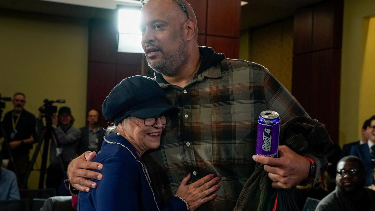 FILE PHOTO: Former U.S. Capitol Police officer Harry Dunn embraces Pamela Hemphill, who pleaded guilty to a misdemeanor for entering the Capitol on January 6, 2021, and rejected her pardon from U.S. President Donald Trump, before the start of a Capitol Hill forum to mark the fifth anniversary of the January 6, 2021, attack on the U.S. Capitol in Washington, D.C., U.S., January 6, 2026. REUTERS/Elizabeth Frantz/File Photo