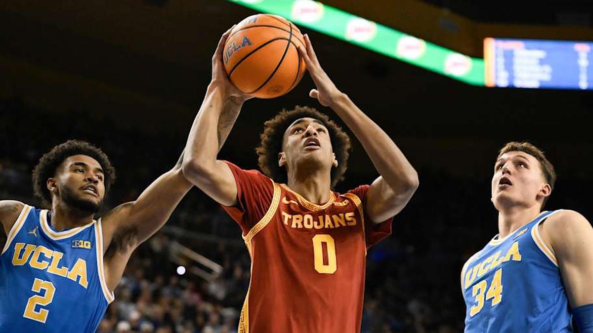  Feb 24, 2026; Los Angeles, California, USA; Southern California Trojans guard Alijah Arenas (0) drives to the basket past UCLA Bruins guard Donovan Dent (2) and forward Tyler Bilodeau (34) during the first half at Pauley Pavilion presented by Wescom Financial. Mandatory Credit: Robert Hanashiro-Imagn Images | Robert Hanashiro-Imagn Images 