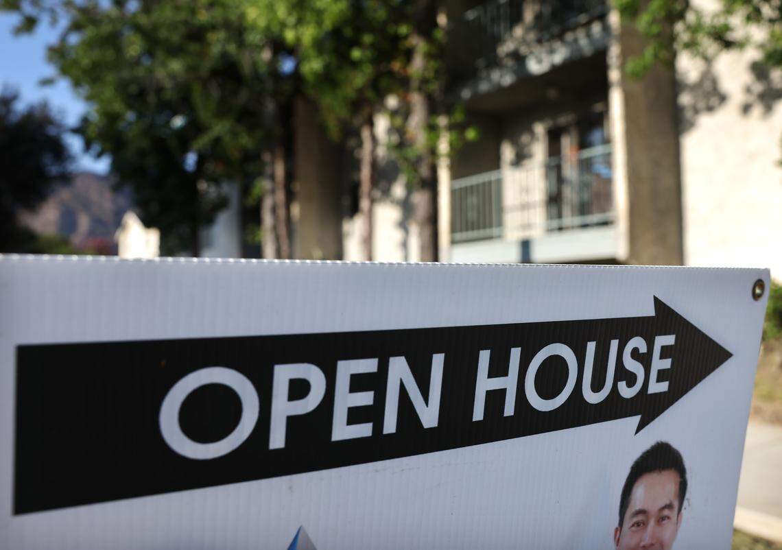 An 'Open House' sign is posted near a single family home for sale on August 22, 2025, in Pasadena, California.