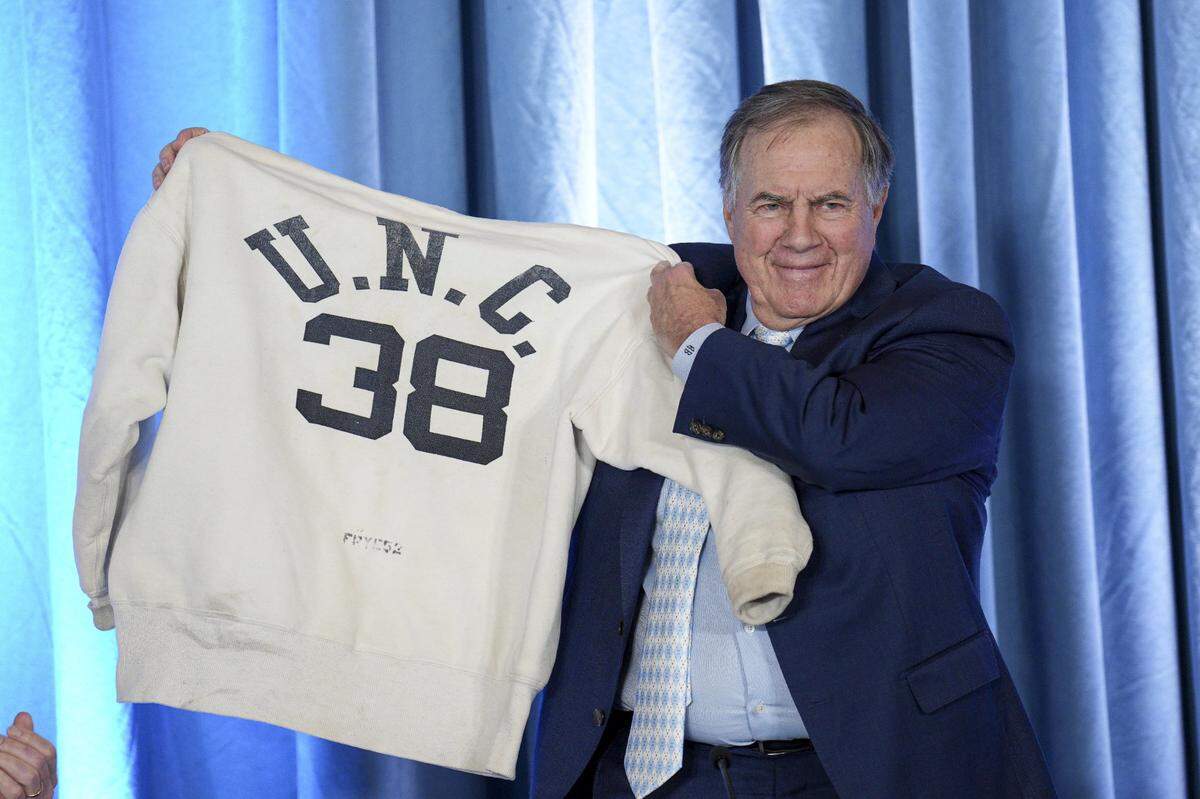 North Carolina Tar Heels new head coach Bill Belichick holds up the sweatshirt worn by his father when he was an assistant coach at New North Carolina Tar Heels new at Loudermilk Center for Excellence in Chapel Hill, NC.