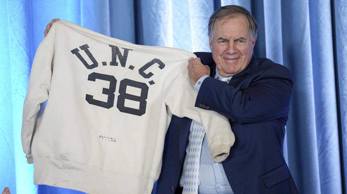 North Carolina Tar Heels new head coach Bill Belichick holds up the sweatshirt worn by his father when he was an assistant coach at New North Carolina Tar Heels new at Loudermilk Center for Excellence in Chapel Hill, NC.