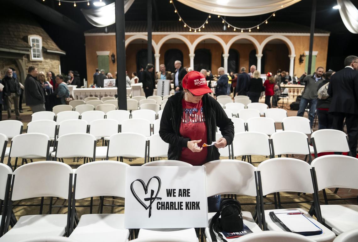 FILE -- A sign is placed on a chair as audience members arrive at a forum for Republican candidates in Georgia's 14th Congressional District on Feb. 12, 2026, in Dalton, Ga. References to Charlie Kirk continue to appear at conservative political events since his assassination. (Nicole Craine/The New York Times)