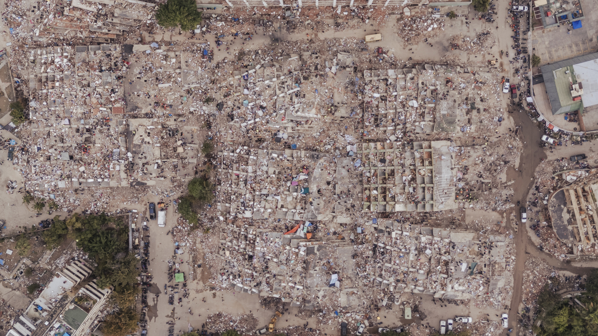 Rescuers search amid a group of collapsed residential buildings in La Guaira, Venezuela, June 30, 2026. After devastating twin earthquakes flattened entire residential neighborhoods last week, experts fear the official death toll of 1,719 could be a serious undercount. (Adriana Loureiro Fernandez/The New York Times)