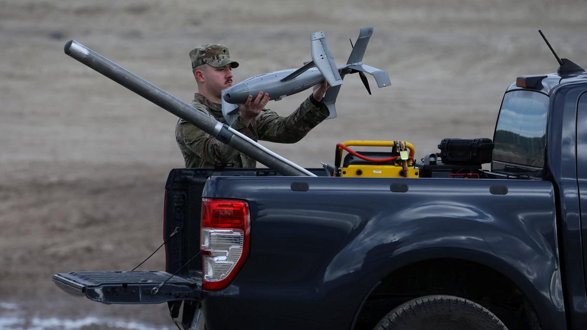 A U.S. soldier installs an AS3 interceptor, part of a modular American-made AI-powered counter-drone system, MEROPS on the back of a truck during a presentation at a polygon in Nowa Deba, Poland, November 18, 2025. REUTERS/Kacper Pempel