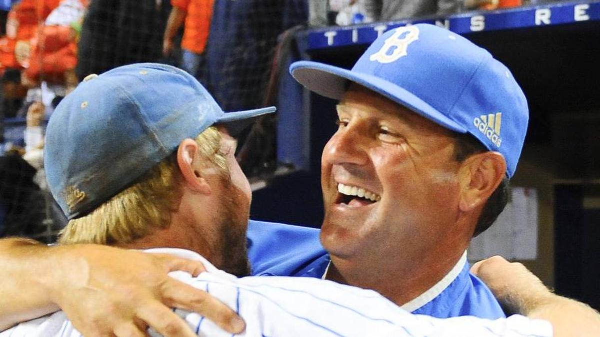  Jun 8, 2013; Fullerton, CA, USA; UCLA Bruins head coach John Savage (22) celebrates with second baseman Cody Regis (18) following a 3-0 win against the Cal State Fullerton Titans to win the Fullerton super regional of the 2013 NCAA baseball tournament at Goodwin Field. Mandatory Credit: Christopher Hanewinckel-Imagn Images | Christopher Hanewinckel-Imagn Images 