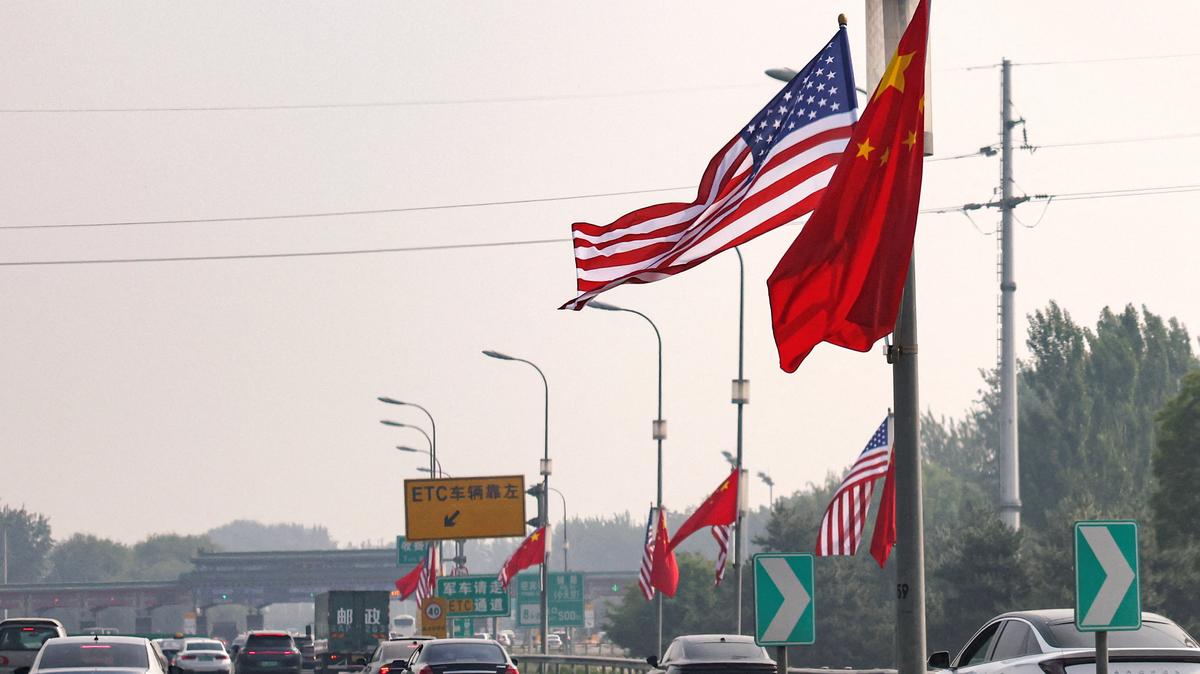 National flags of China and the United States flutter on a road, ahead of the U.S. President Donald Trump's state visit to China, in Beijing, China, May 13, 2026. REUTERS/Tingshu Wang