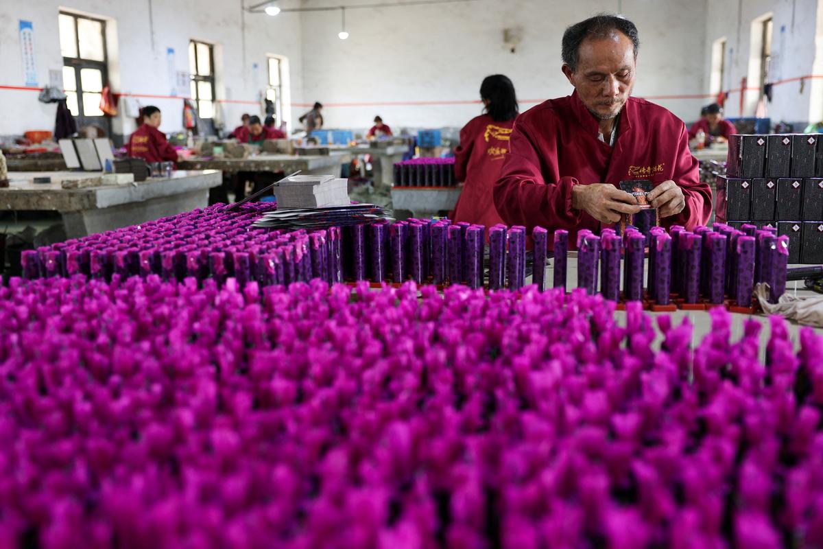Employees work to assemble firework products at Chili Fireworks in Liling, Hunan province, China, April 10, 2026.  REUTERS/Go Nakamura