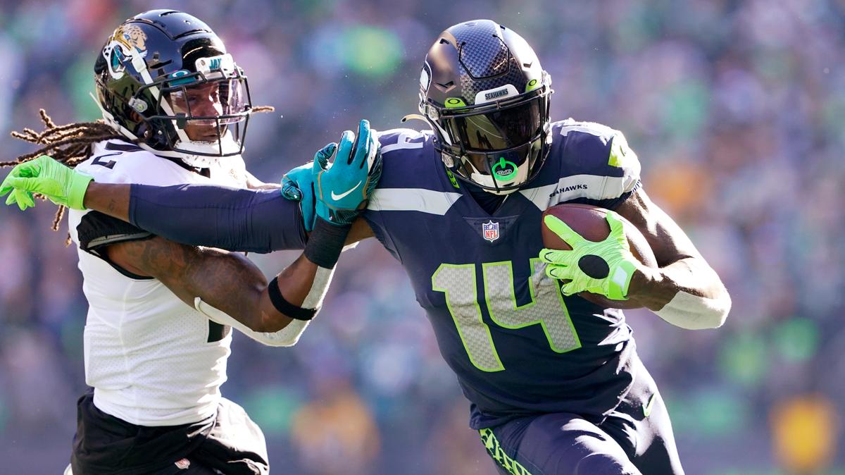 Seattle Seahawks’ DK Metcalf (14) pushes off of Jacksonville Jaguars’ Rayshawn Jenkins as he runs with the ball during the first half of an NFL football game, Sunday, Oct. 31, 2021, in Seattle. (AP Photo/Ted S. Warren)