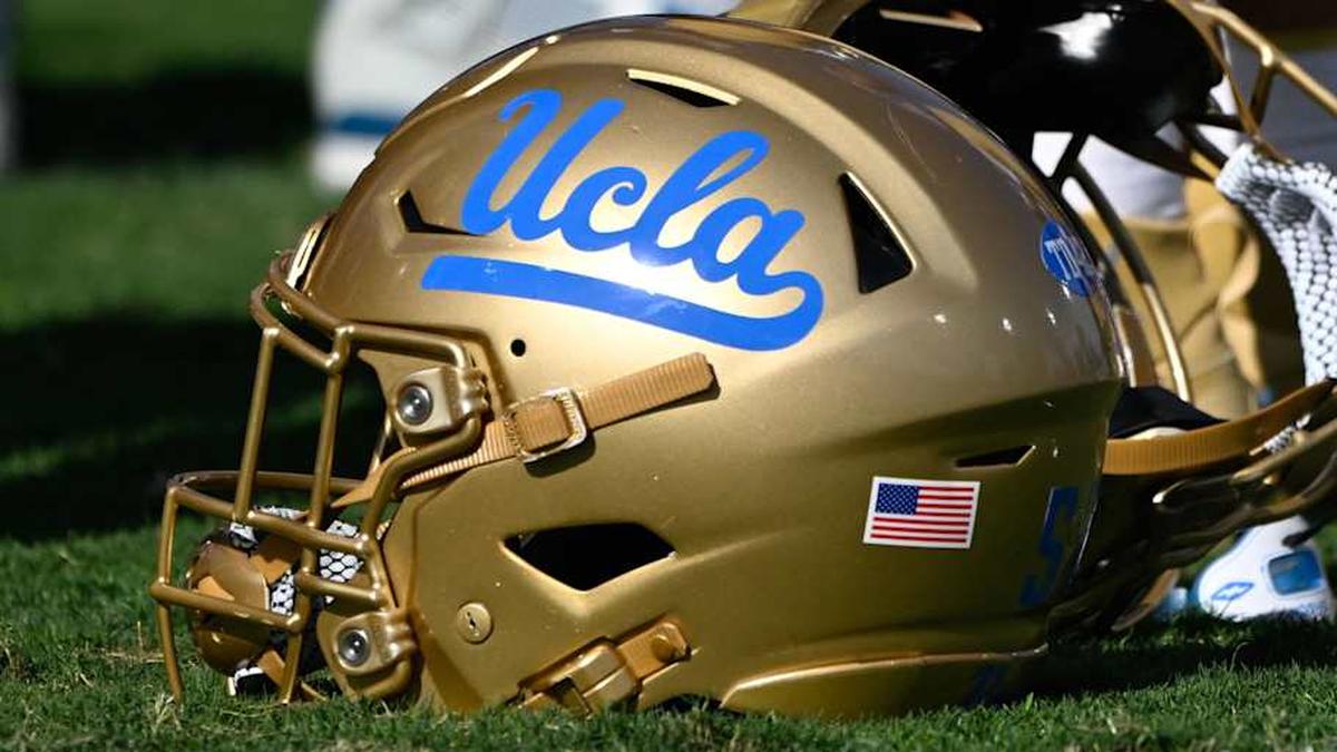  Nov 30, 2024; Pasadena, California, USA; UCLA Bruins helmets during pregame warmups before playing the Fresno State Bulldogs at Rose Bowl. Mandatory Credit: Robert Hanashiro-Imagn Images | Robert Hanashiro-Imagn Images 