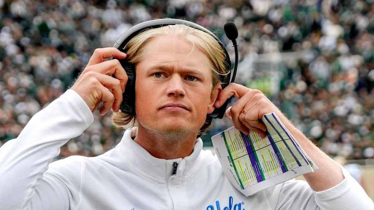  UCLA's assistant head coach Jerry Neuheisel adjusts his headset during the third quarter in the game against Michigan State on Saturday, Oct. 11, 2025, at Spartan Stadium in East Lansing. | Nick King/Lansing State Journal / USA TODAY NETWORK via Imagn Images 