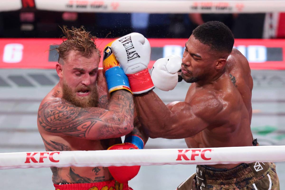  Dec 19, 2025; Miami, Florida, UNITED STATES; Anthony Joshua hits Jake Paul during a heavyweight boxing bout at Kaseya Center. Mandatory Credit: Sam Navarro-Imagn Images Sam Navarro-Imagn Images