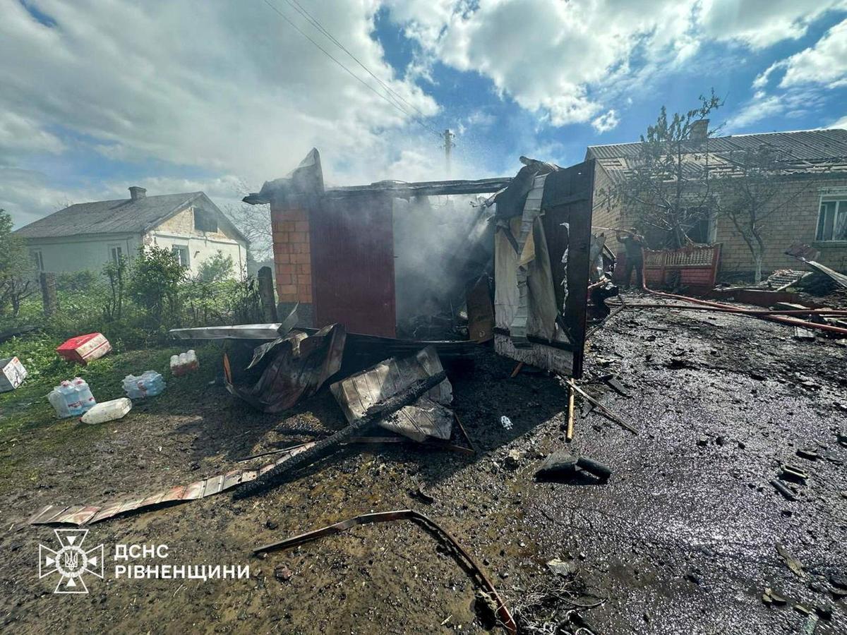 A man works to extinguish fire at the site of a residential building damaged during a Russian drone strike, amid Russia's attack on Ukraine, in Rivne region, Ukraine May 13, 2026. Press service of the State Emergency Service of Ukraine in Rivne region/Handout via REUTERS
