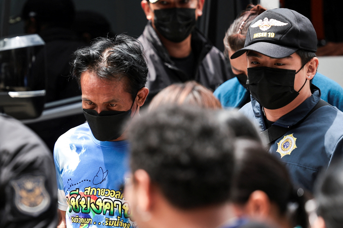Two suspects, a Thai man and his Laotian wife, suspected of sending drug parcels from a border province to Bangkok, are escorted by officials to the Office of the Narcotics Control Board (ONCB) in Bangkok, Thailand, July 3, 2026. REUTERS/Chalinee Thirasupa