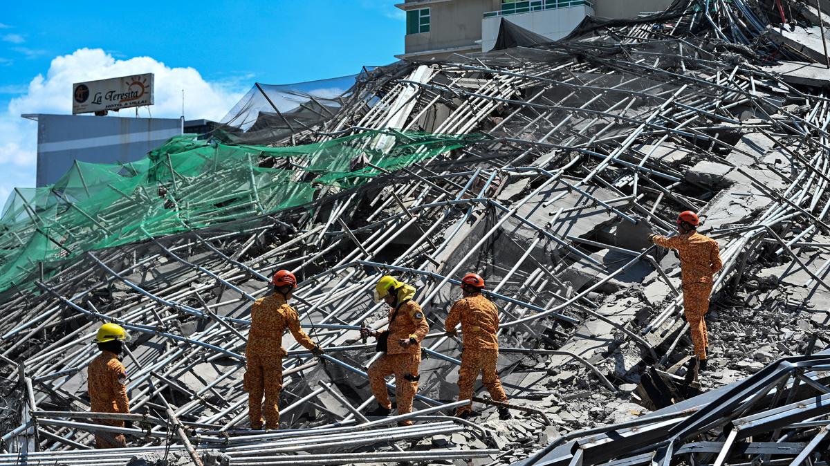 Rescue workers search for survivors among debris as a nine-story building under construction collapsed in Balibago, Angeles City, Pampanga, Philippines, May 24, 2026. REUTERS