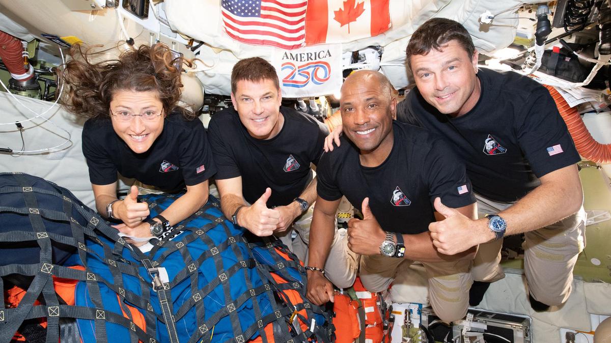 The Artemis II crew, from left, Mission Specialist Christina Koch, Mission Specialist Jeremy Hansen, Pilot Victor Glover, and Commander Reid Wiseman, pause for a group photo inside the Orion spacecraft on their way home. Following a swing around the far side of the Moon on April 6, 2026, the crew exited the lunar sphere of influence (the point at which the Moon's gravity has a stronger pull on Orion than the Earth's) on April 7, and are headed back to Earth for a splashdown in the Pacific Ocean on April 10. (NASA/TNS)