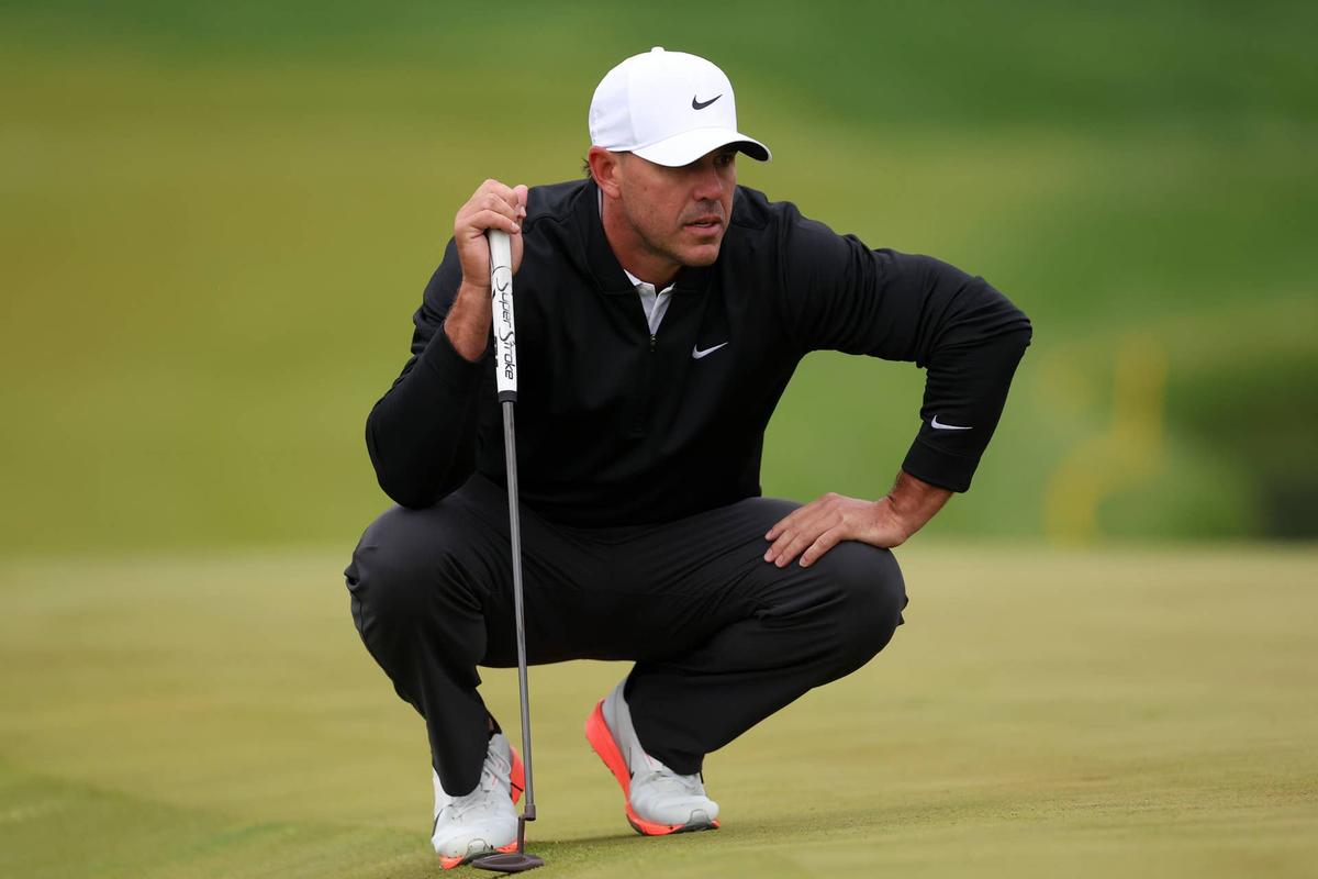  May 14, 2026; Newtown Square, Pennsylvania, USA; Brooks Koepka lines up a putt on the tenth green during the first round of the PGA Championship golf tournament at Aronimink Golf Club. Mandatory Credit: Bill Streicher-Imagn Images